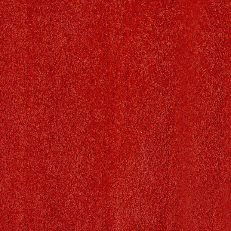 Textura granular e irregular em tons de vermelho vibrante, com pequenos pontos mais escuros.